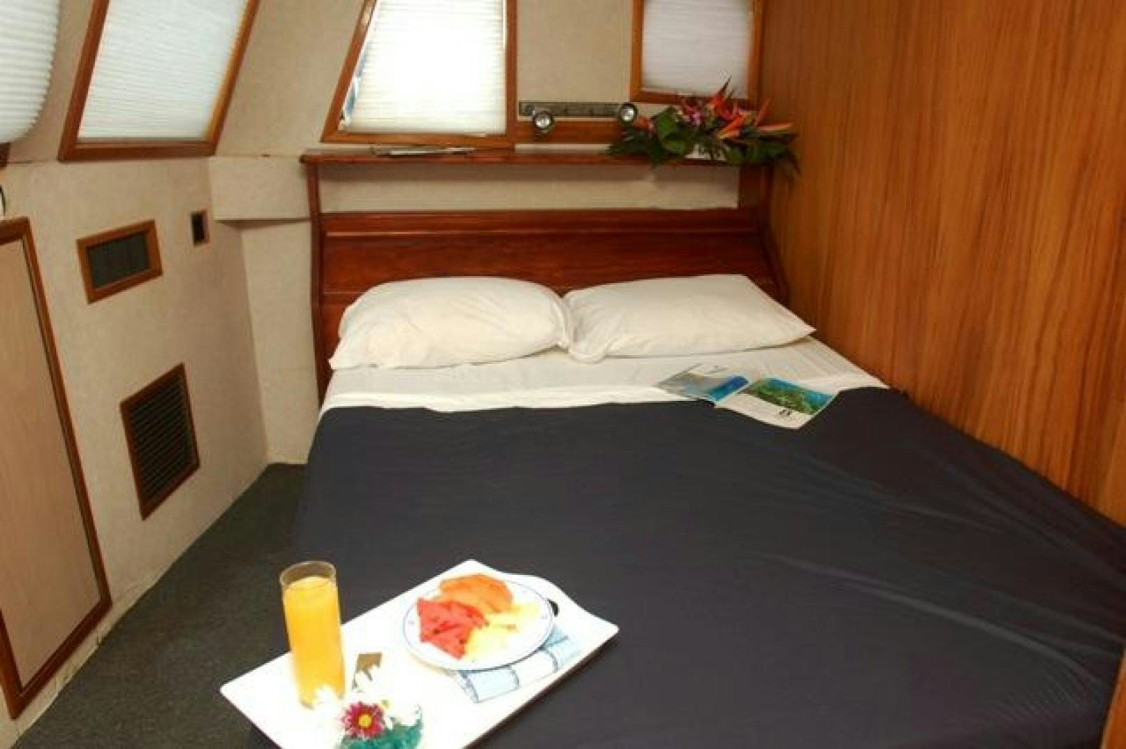 a bed with a tray of food aboard No Name Yacht for Sale
