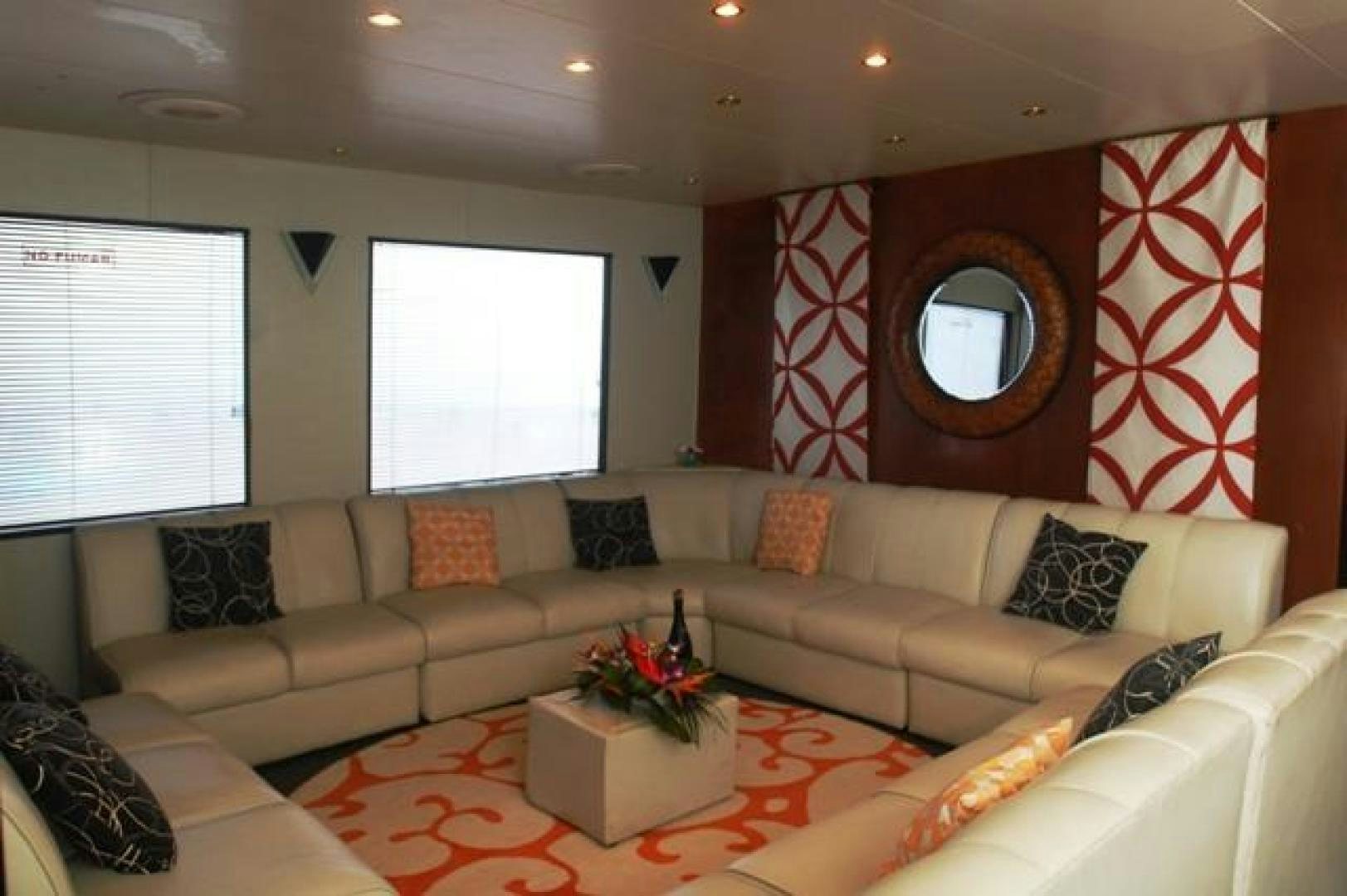 a living room with a couch and a mirror aboard No Name Yacht for Sale