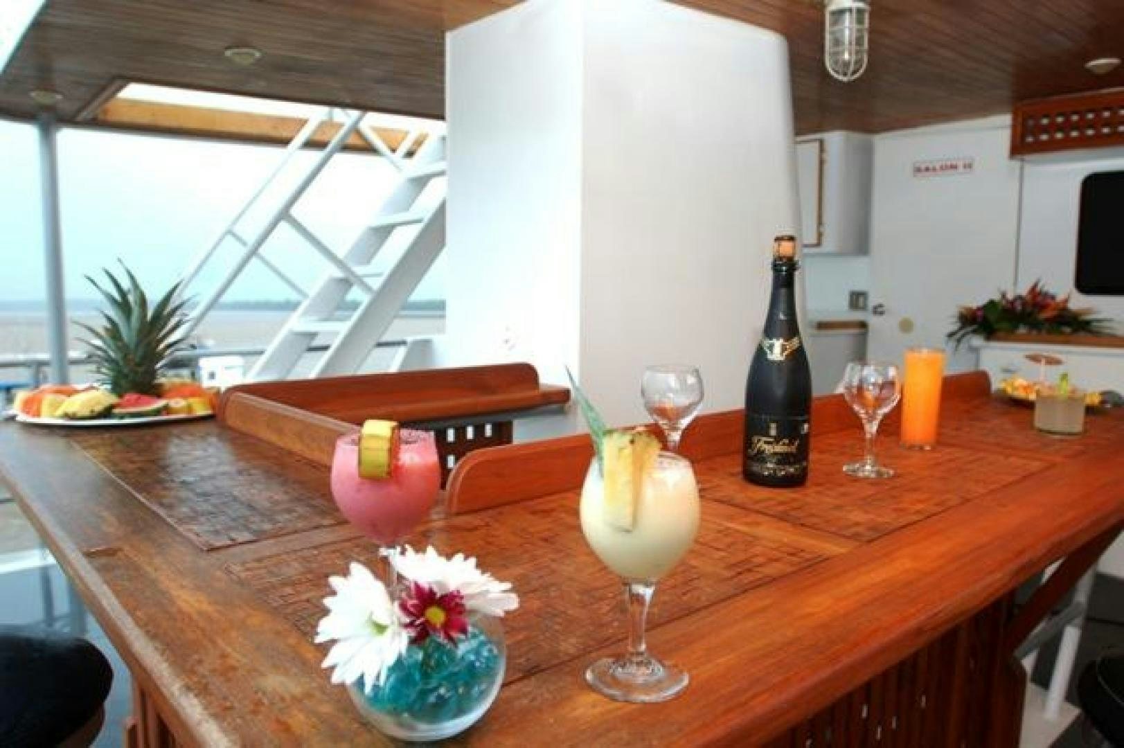 a table with glasses and food on it aboard No Name Yacht for Sale