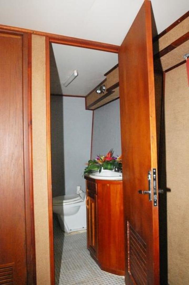 a bathroom with a wood door aboard No Name Yacht for Sale