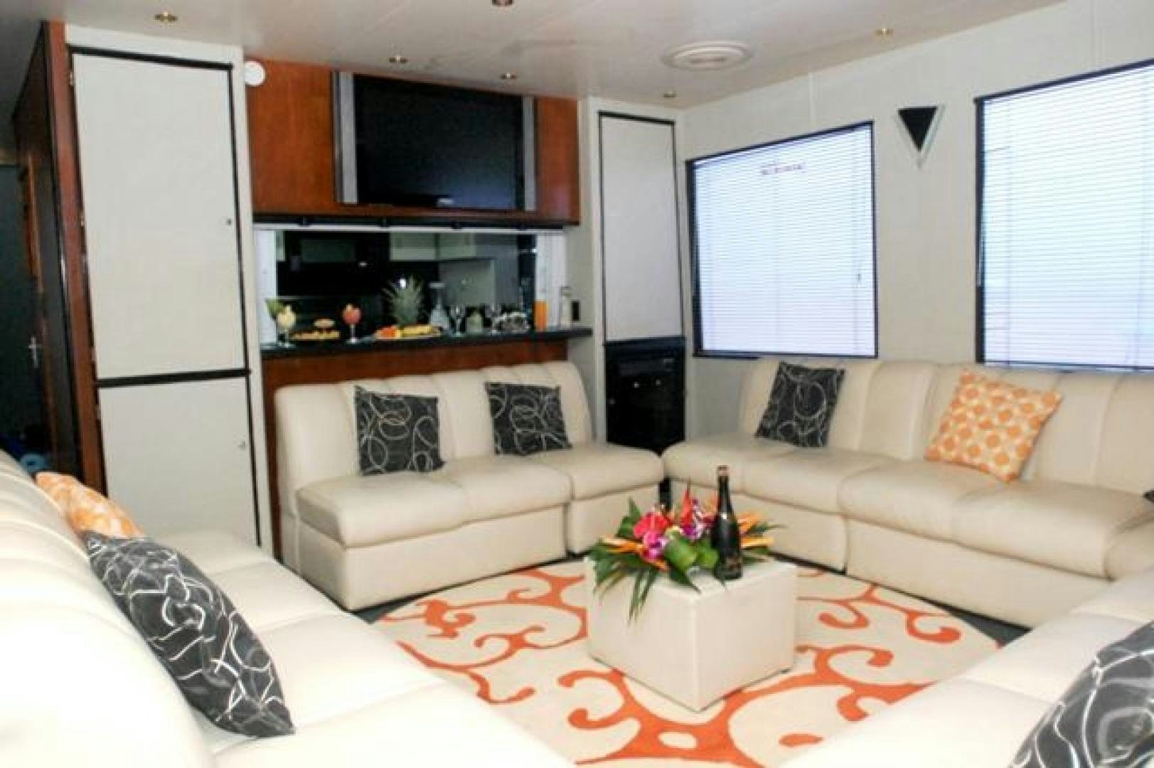 a living room with white furniture aboard No Name Yacht for Sale