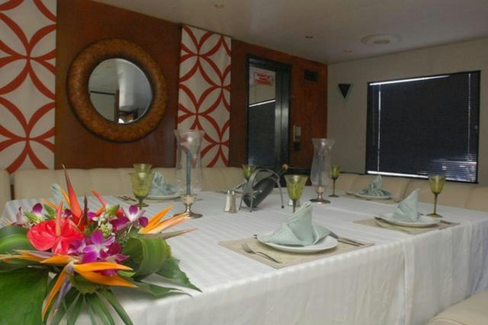 a table with wine glasses and plates aboard No Name Yacht for Sale