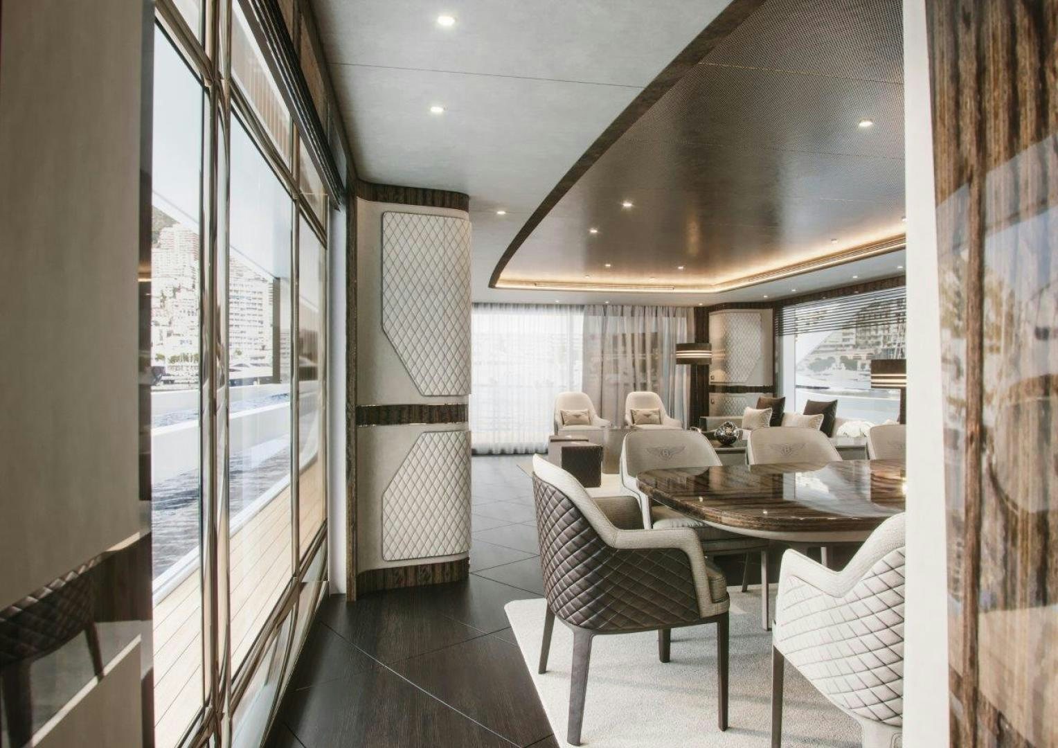 a room with a table chairs and a window aboard G 300 Yacht for Sale