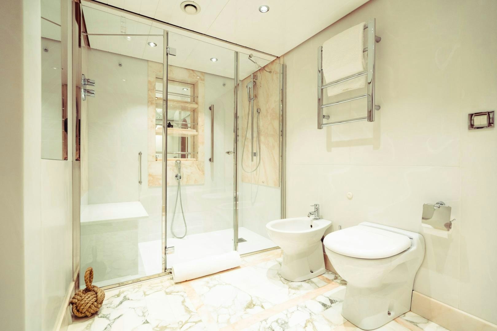 a bathroom with a glass shower aboard WIZARD Yacht for Sale