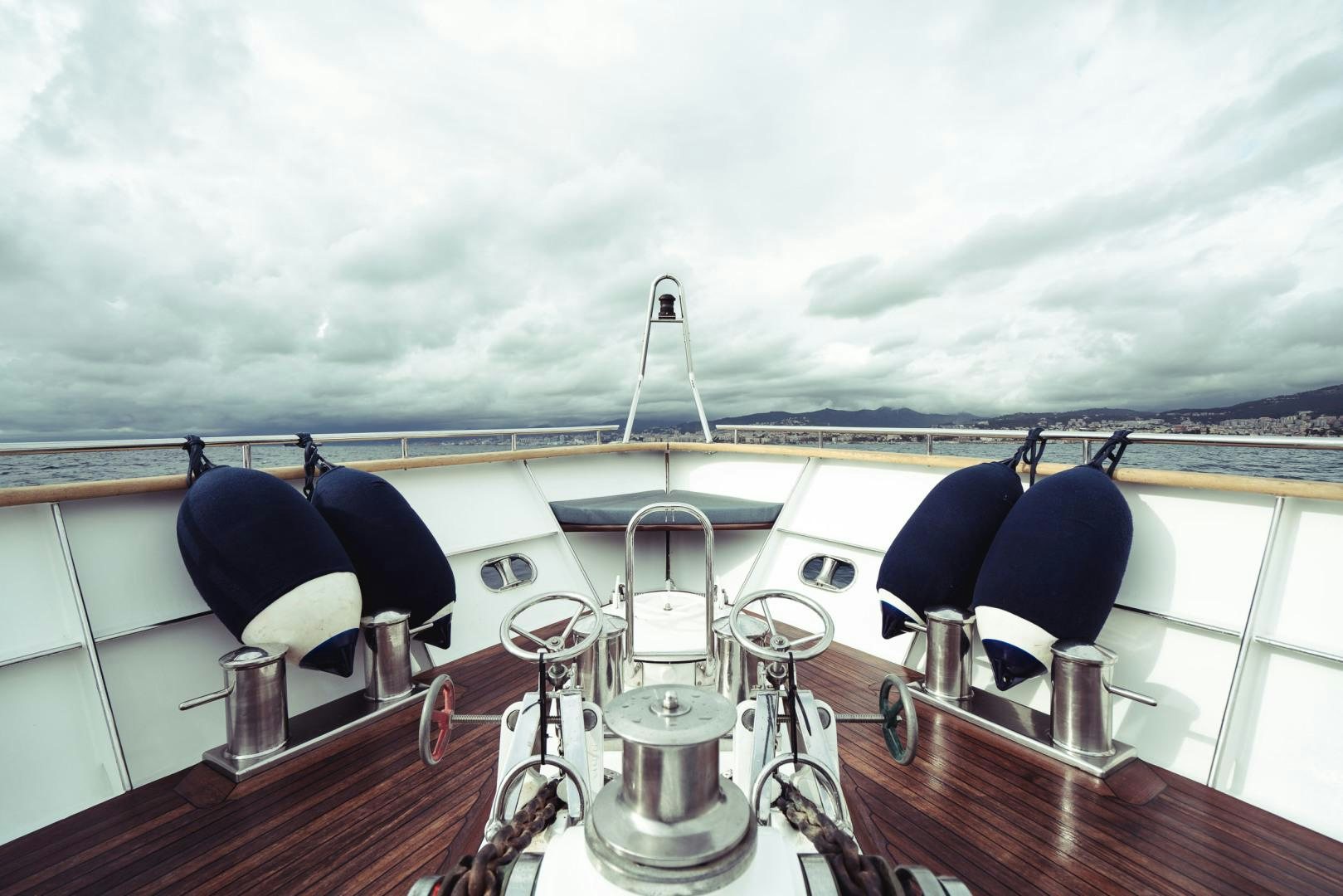 a boat with a large ship in the background aboard WIZARD Yacht for Sale