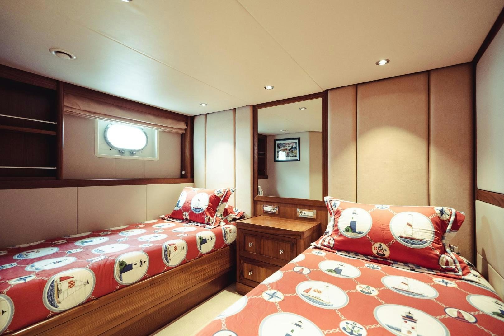 a bedroom with a bed and a dresser aboard WIZARD Yacht for Sale