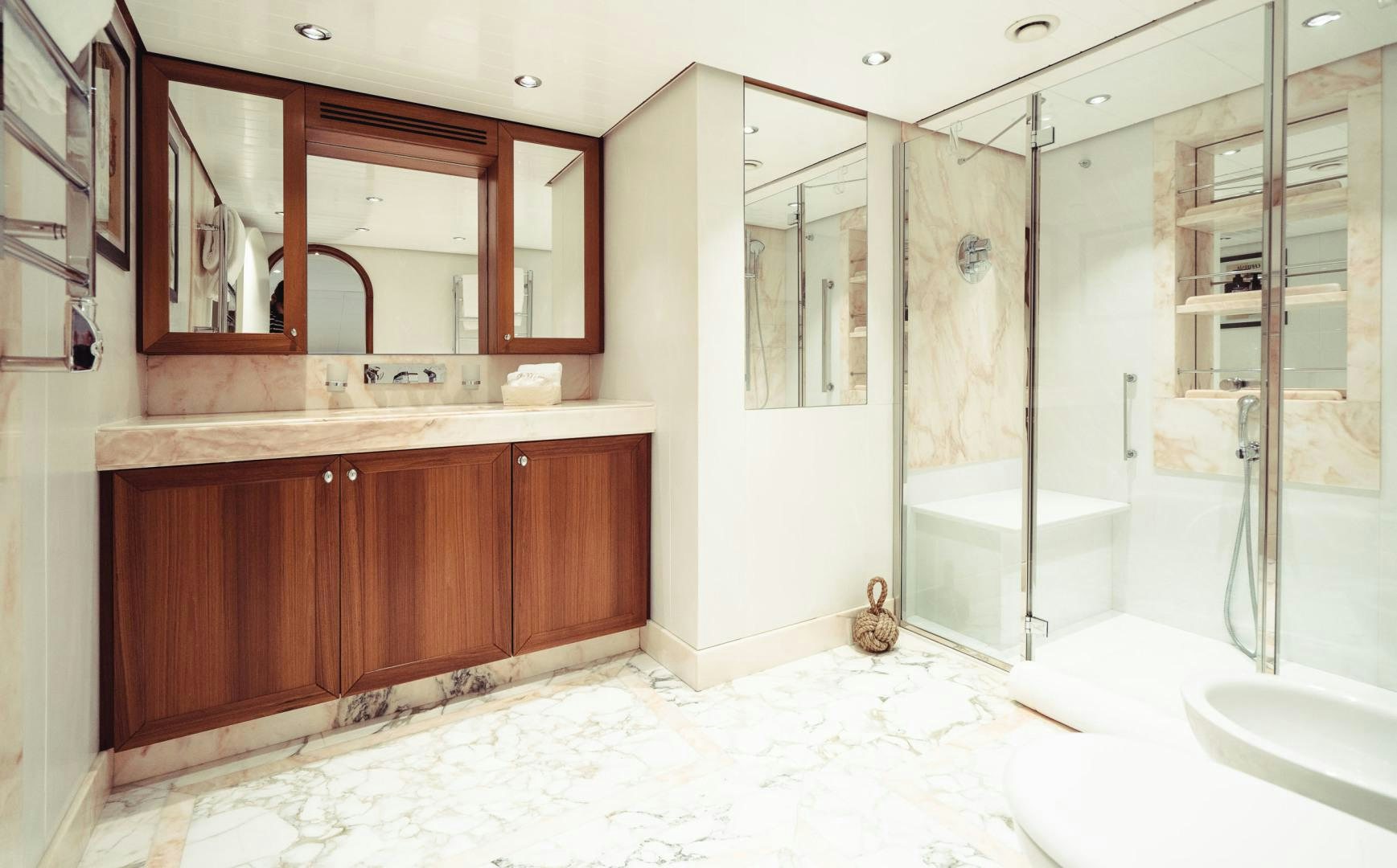 a bathroom with a glass shower aboard WIZARD Yacht for Sale