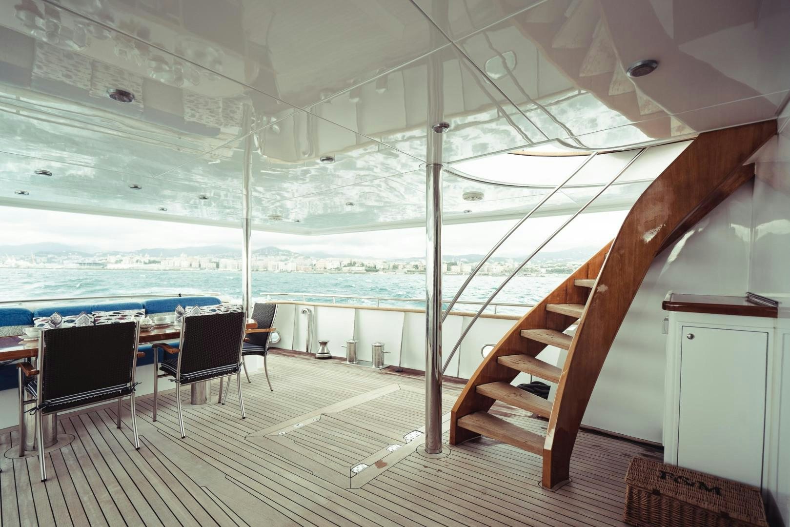 a wood staircase leading to a balcony aboard WIZARD Yacht for Sale