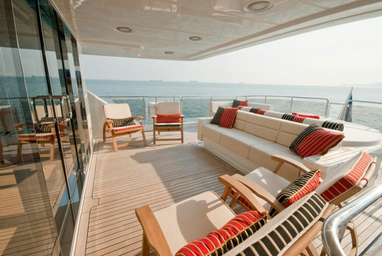 a large living room with a large balcony overlooking the ocean aboard RED PEARL Yacht for Sale