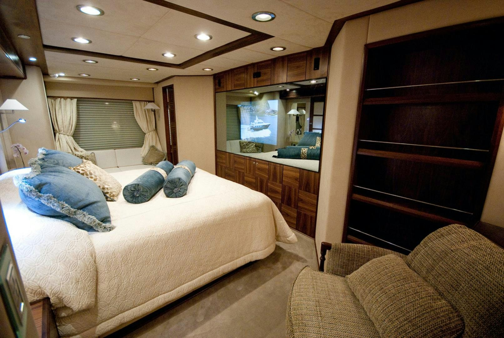 a bedroom with a bed and a large mirror aboard RED PEARL Yacht for Sale