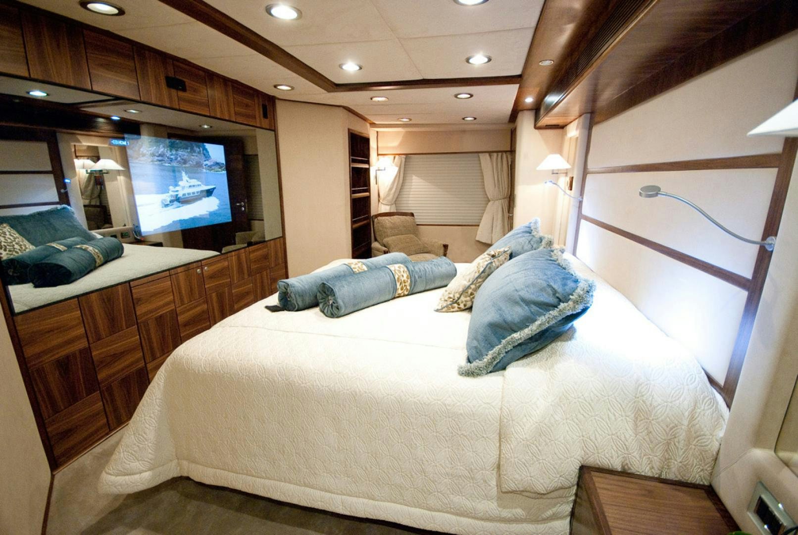 a bedroom with a bed and a television aboard RED PEARL Yacht for Sale