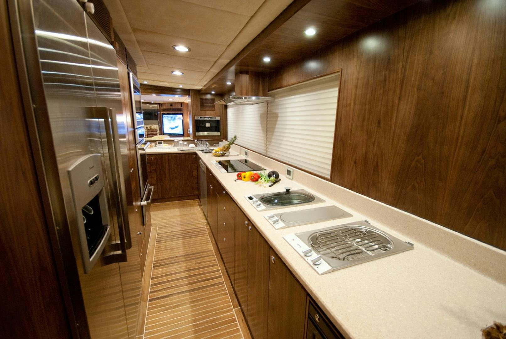 a kitchen with a stainless steel refrigerator aboard RED PEARL Yacht for Sale