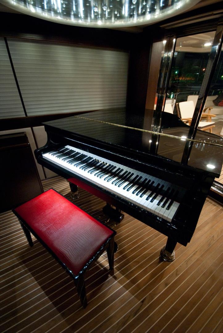 a piano in a room aboard RED PEARL Yacht for Sale