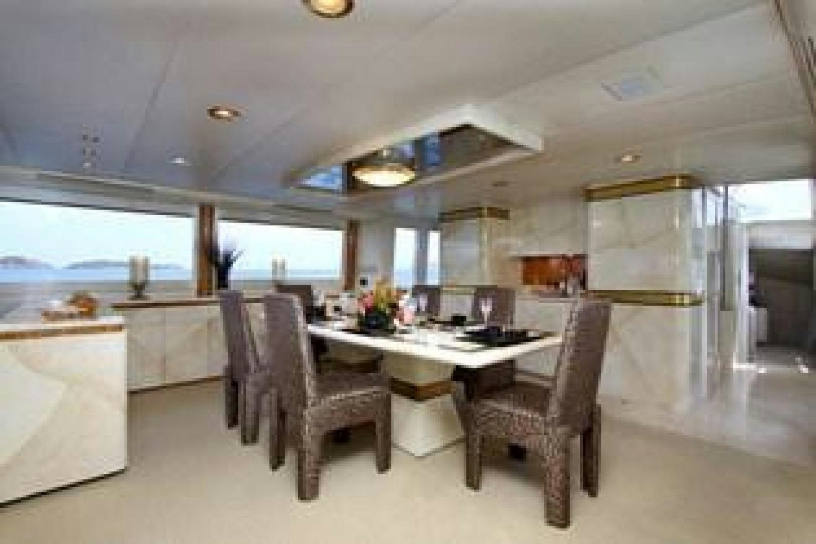 a kitchen with a table and chairs aboard HARLINA Yacht for Sale