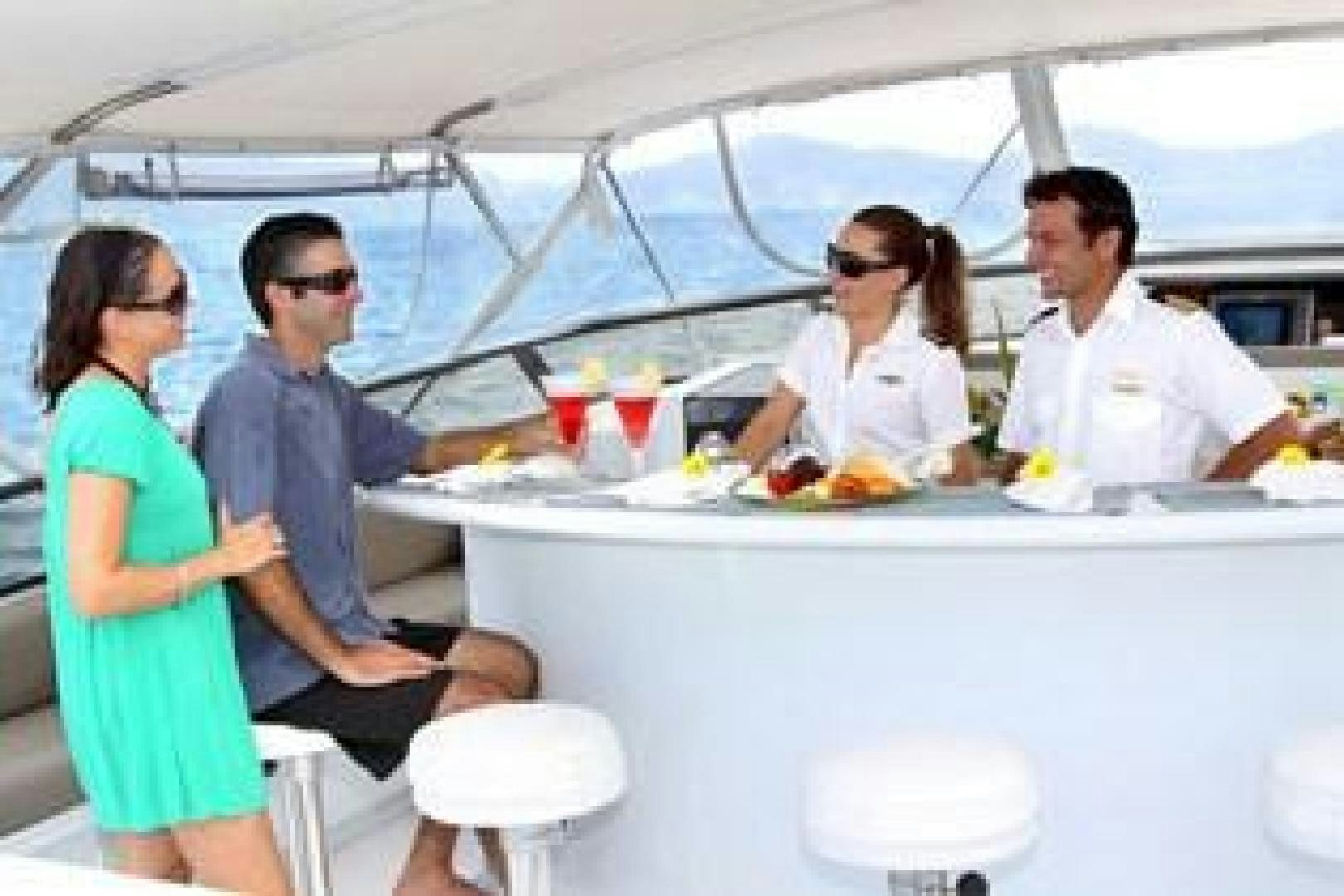 a group of people sitting at a table aboard HARLINA Yacht for Sale