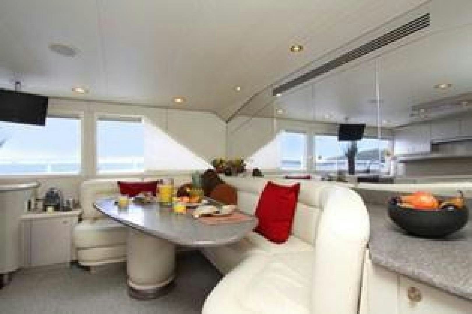 a room with a table and chairs aboard HARLINA Yacht for Sale