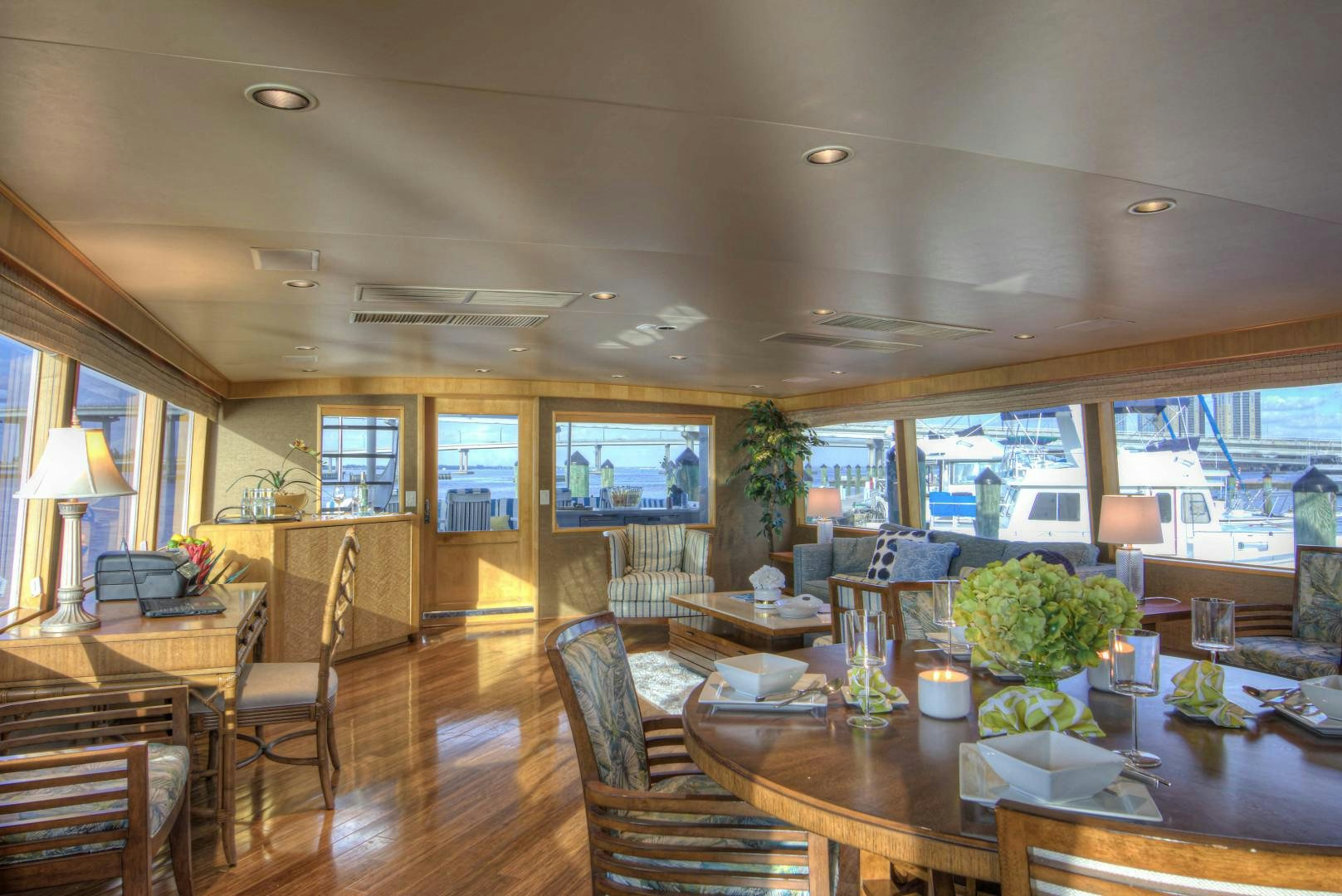 a large living room with a wood floor and a large screen aboard LADY LEX Yacht for Sale