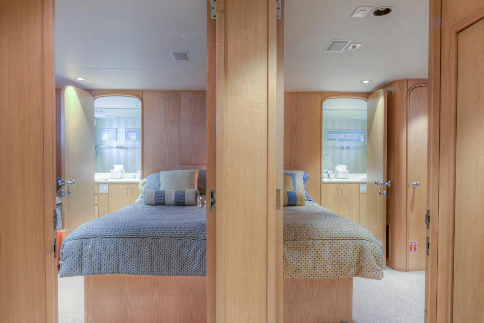 a room with a bed and a door aboard LADY LEX Yacht for Sale