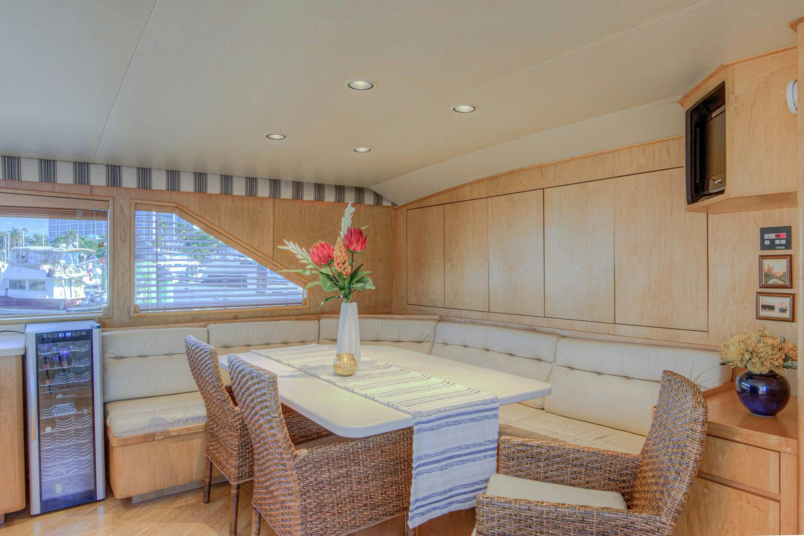 a living room with a table and chairs aboard LADY LEX Yacht for Sale