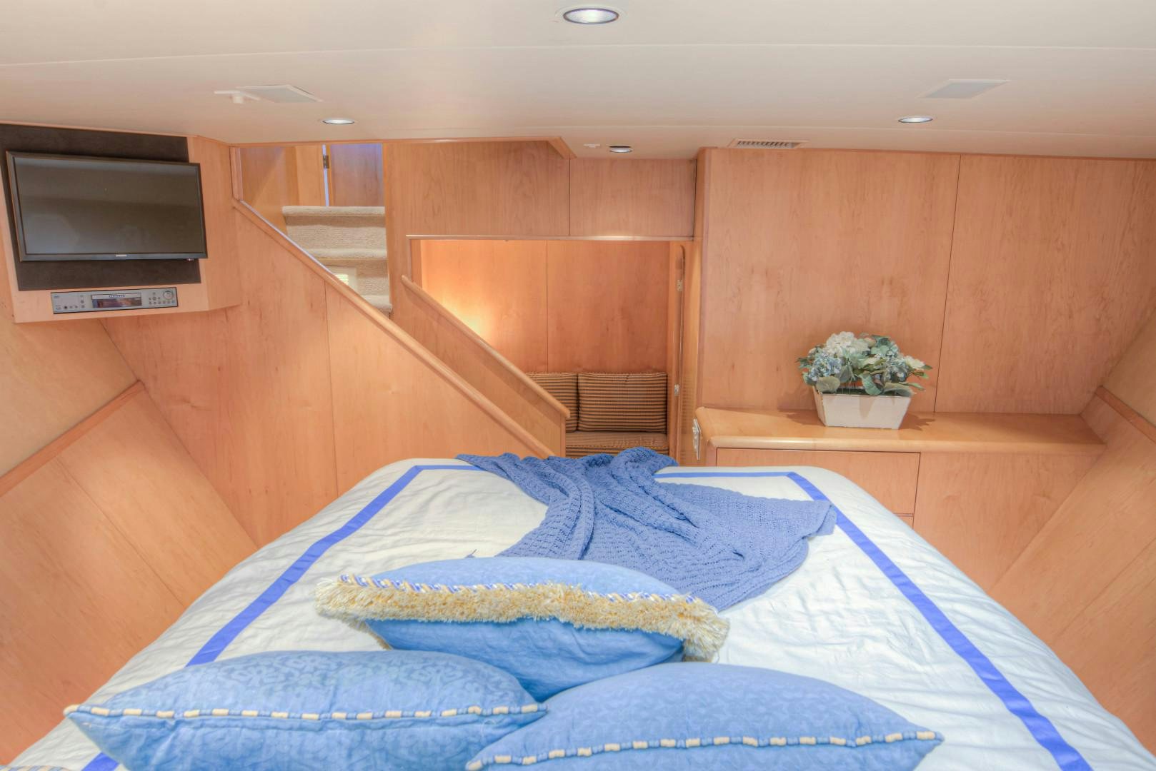 a room with a bed and a wood wall aboard LADY LEX Yacht for Sale