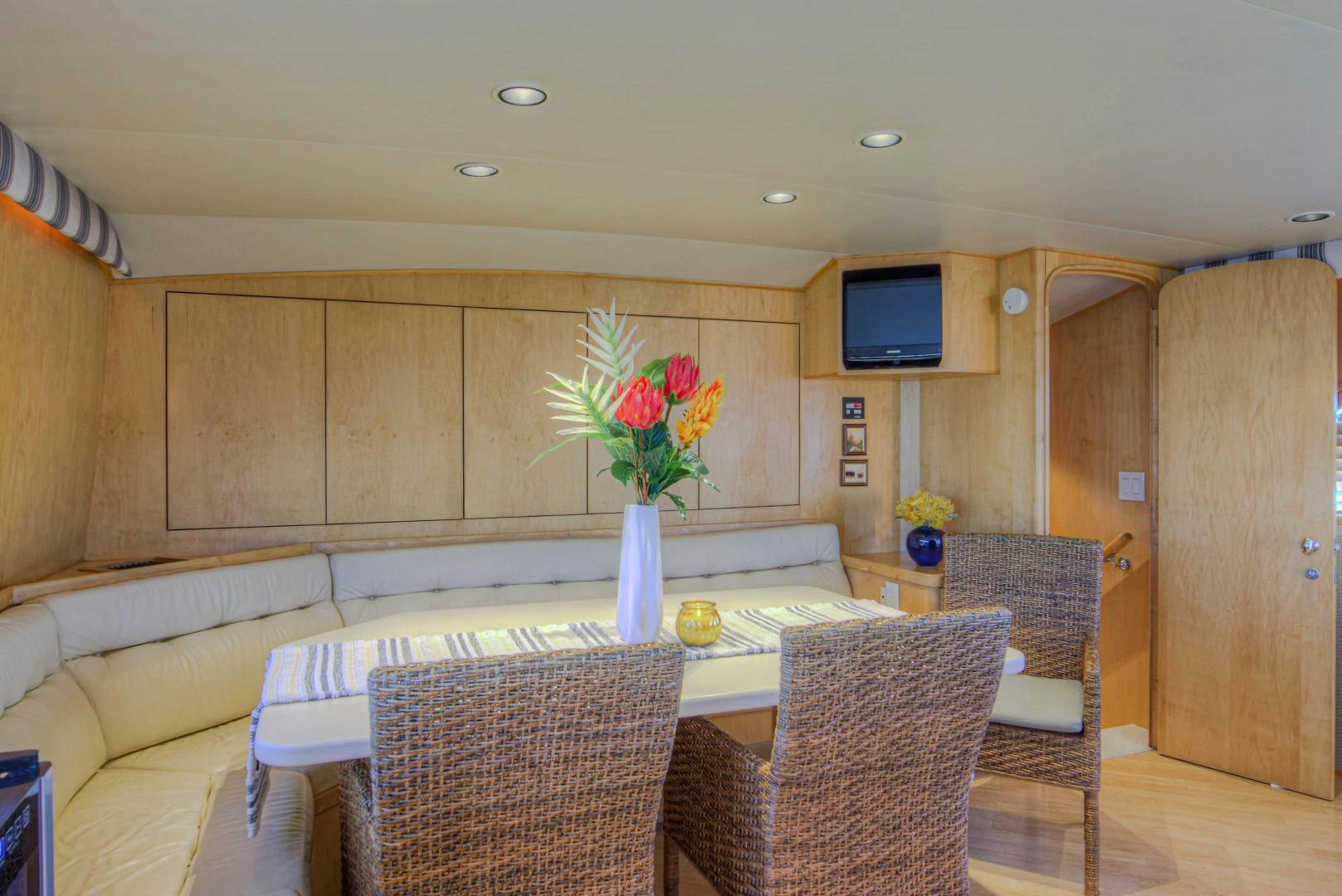 a living room with a table and chairs aboard LADY LEX Yacht for Sale