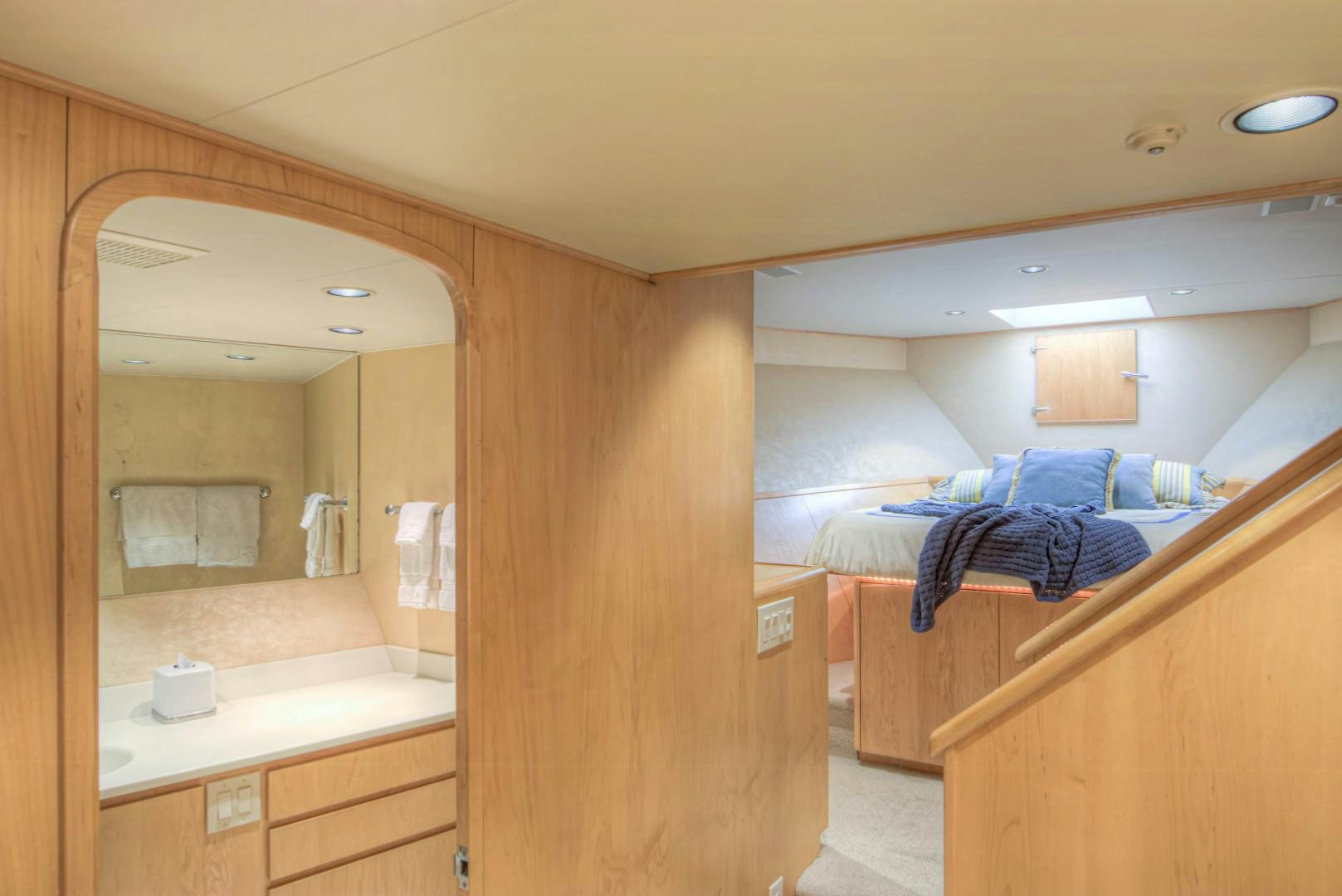 a bathroom with a mirror and a bed aboard LADY LEX Yacht for Sale