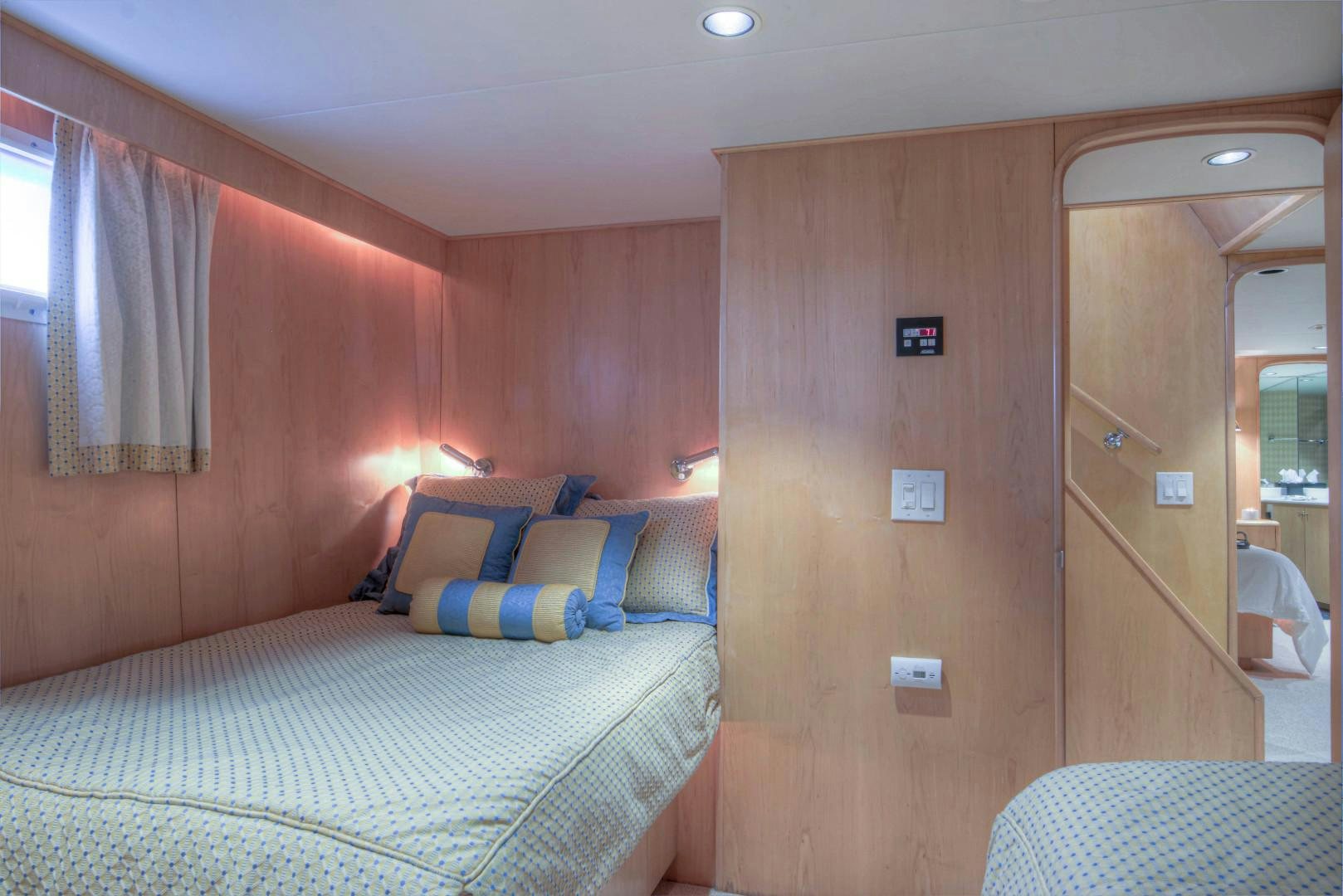 a bedroom with a bed and a mirror aboard LADY LEX Yacht for Sale
