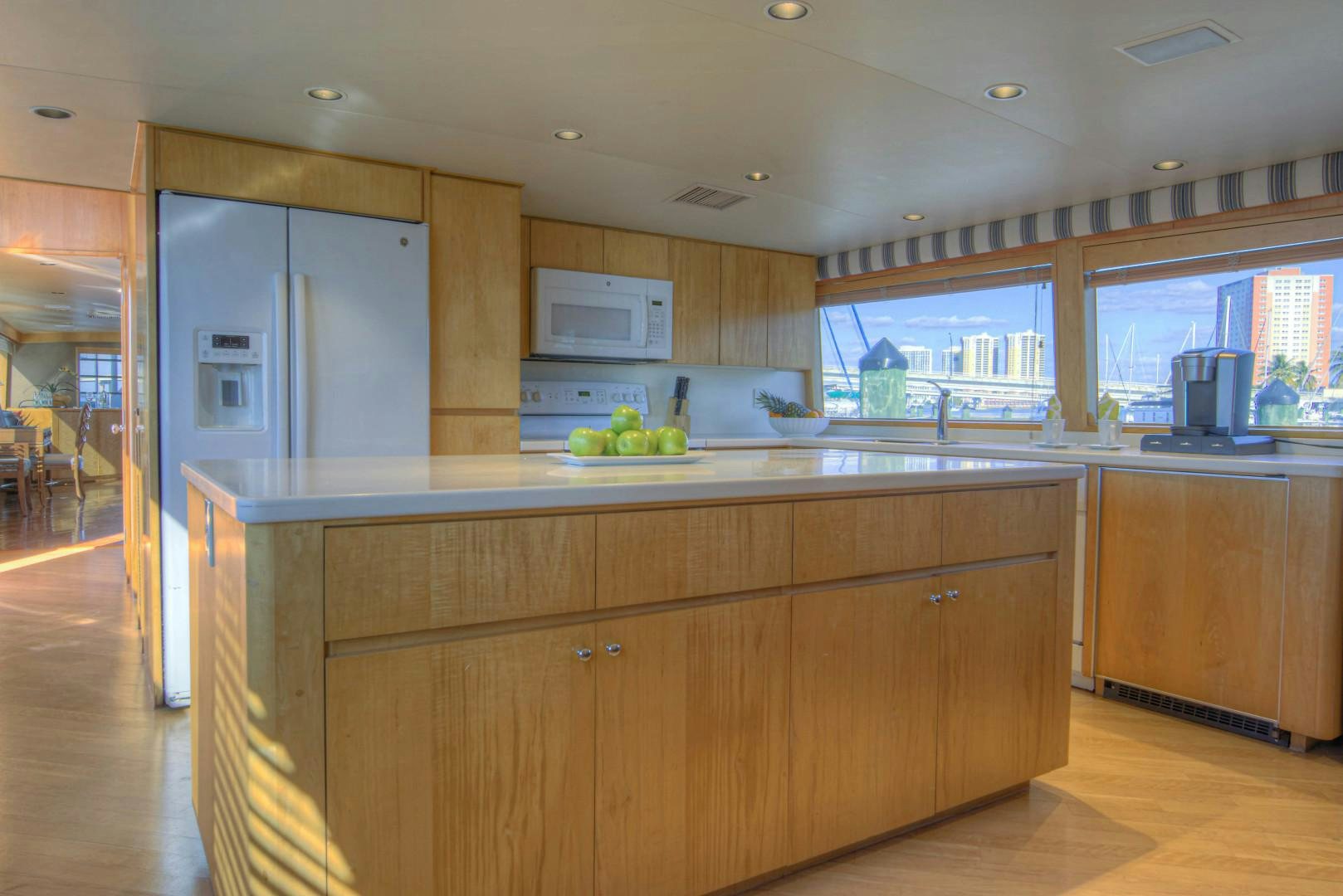 a kitchen with wooden cabinets aboard LADY LEX Yacht for Sale