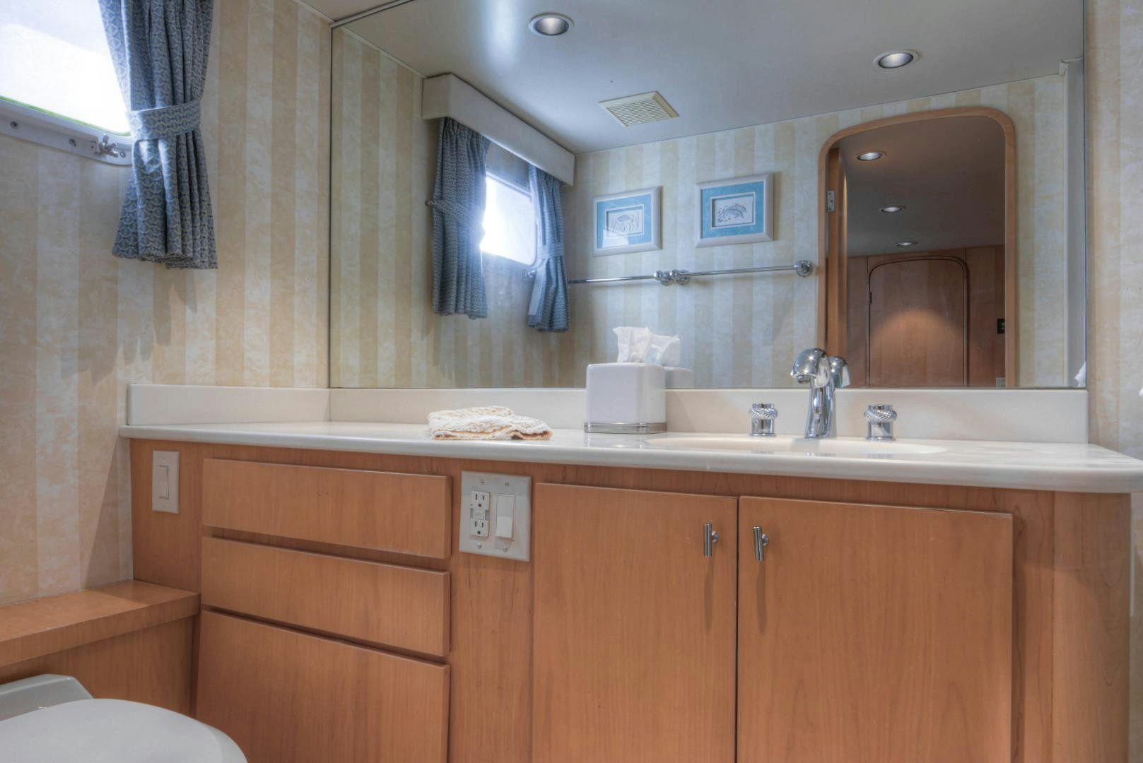 a bathroom with a countertop sink and cabinets aboard LADY LEX Yacht for Sale