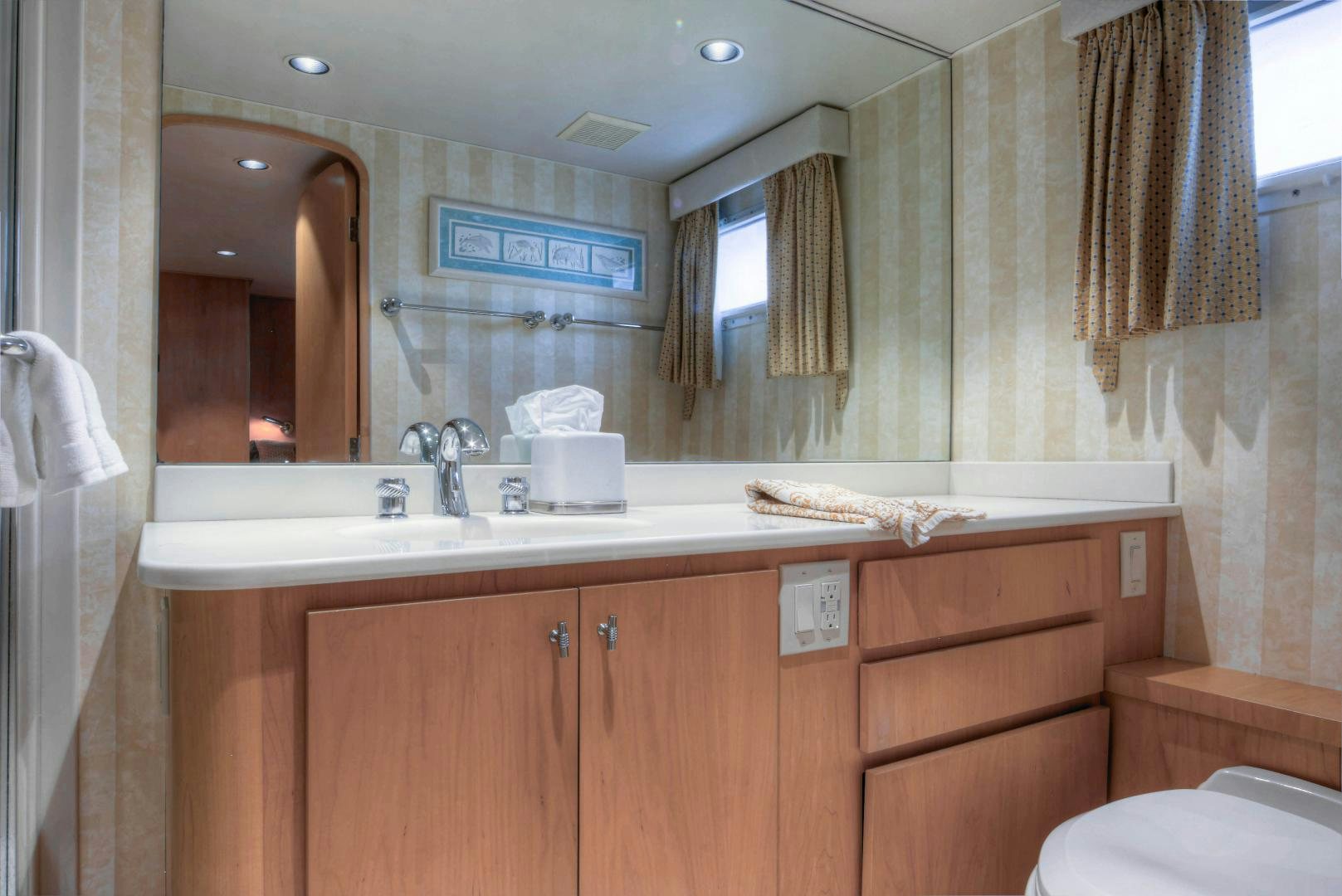 a bathroom with a large mirror aboard LADY LEX Yacht for Sale