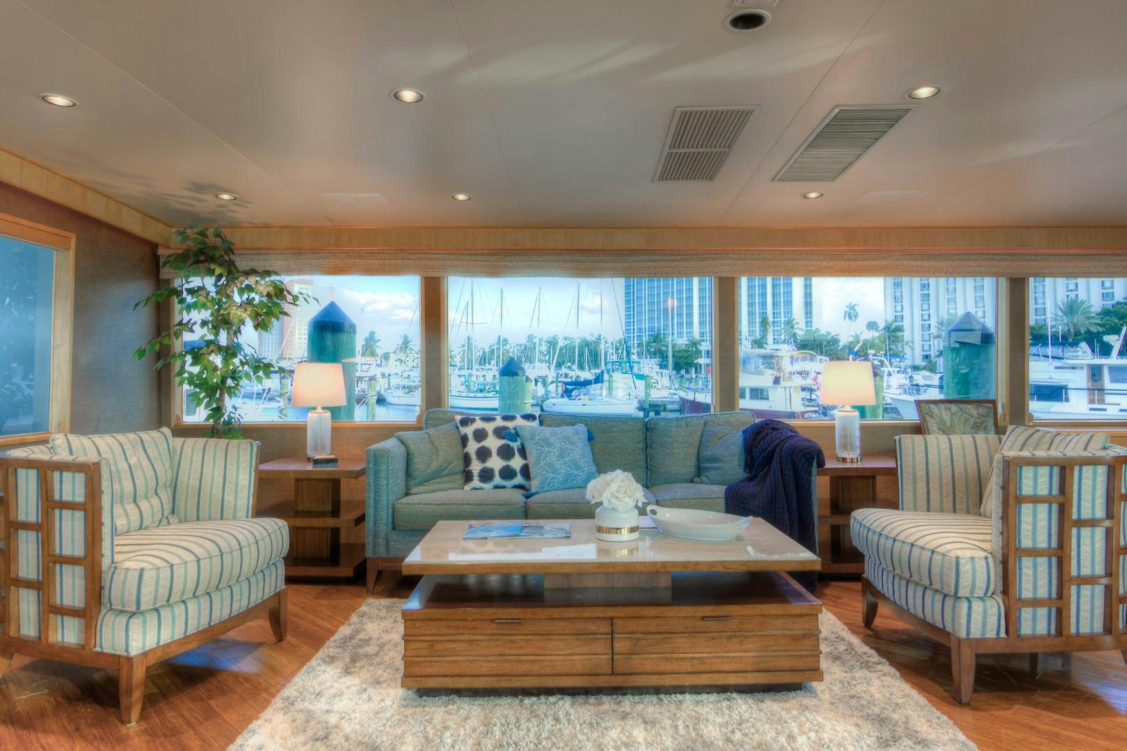 a living room with a large window aboard LADY LEX Yacht for Sale