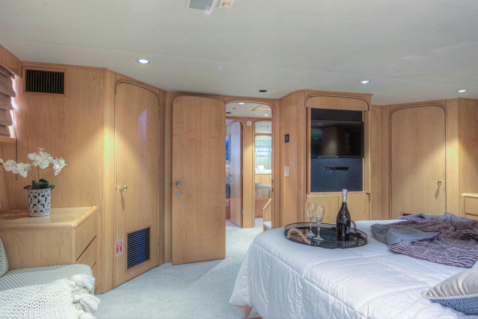 a bedroom with a bed and a desk aboard LADY LEX Yacht for Sale