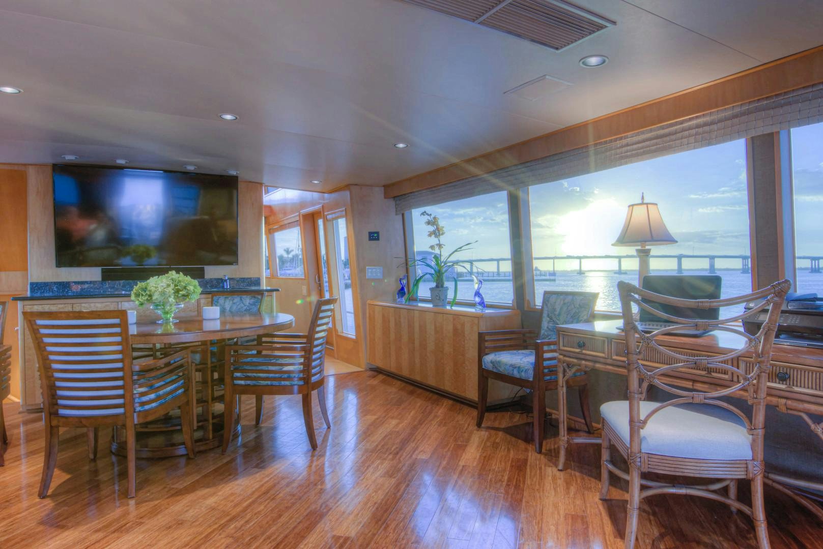a large dining room with wood floors aboard LADY LEX Yacht for Sale