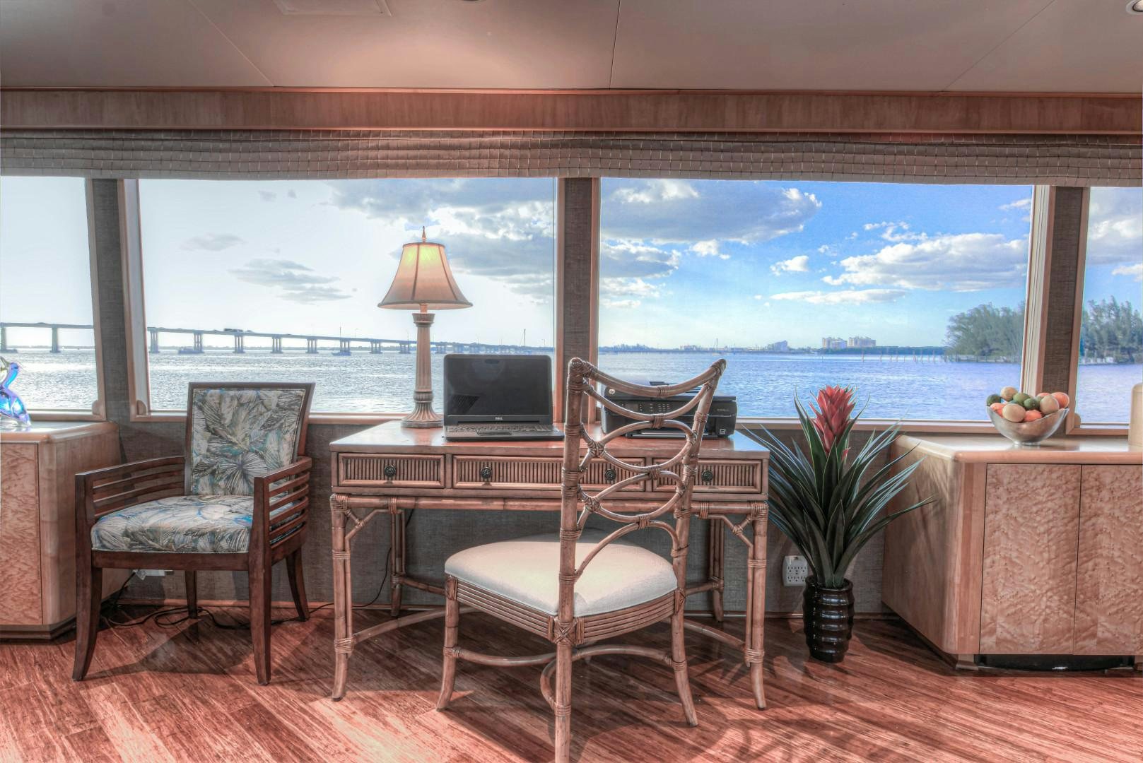 a room with a table and chairs aboard LADY LEX Yacht for Sale
