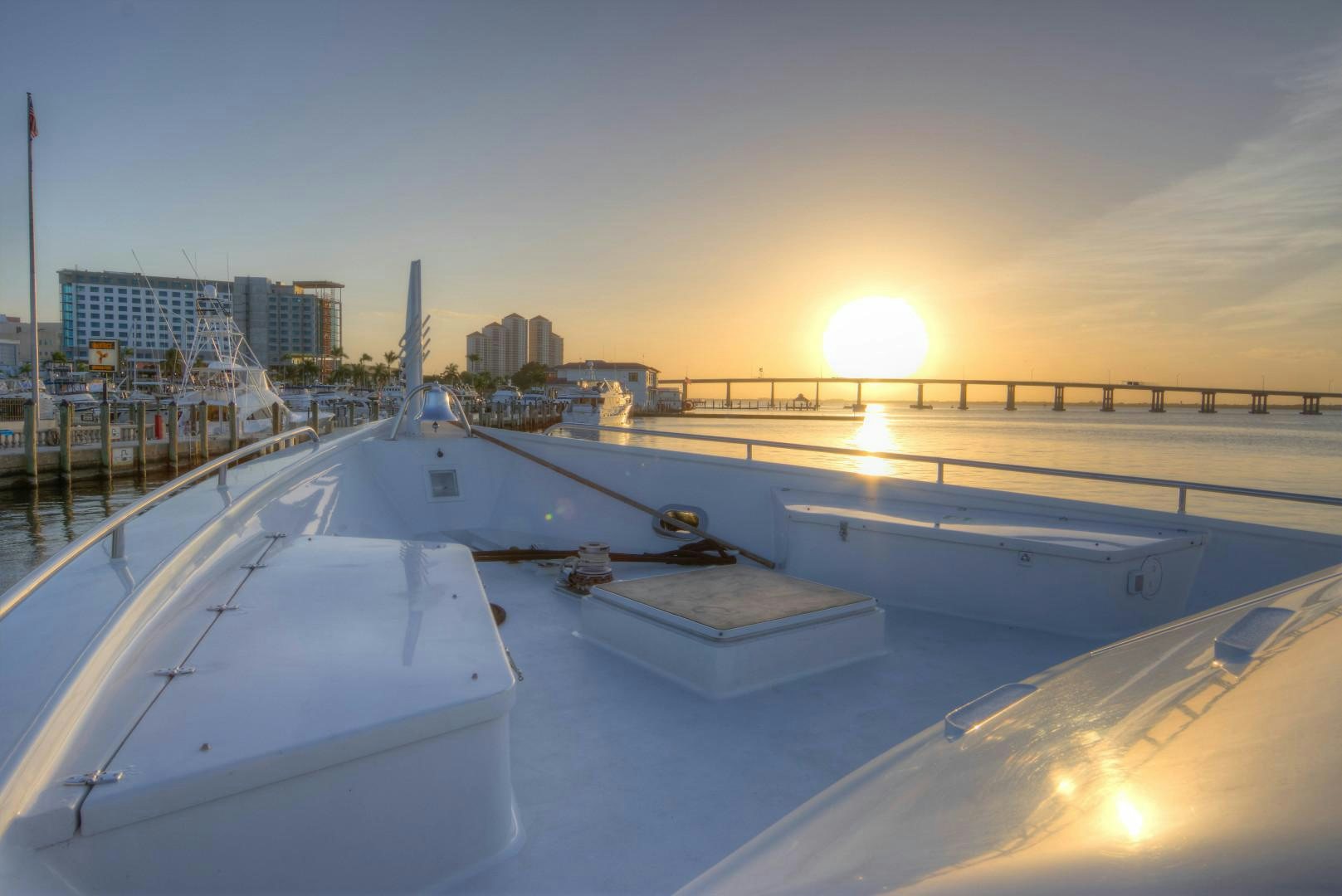 a large building with a large white roof and a large body of water with a city in the aboard LADY LEX Yacht for Sale