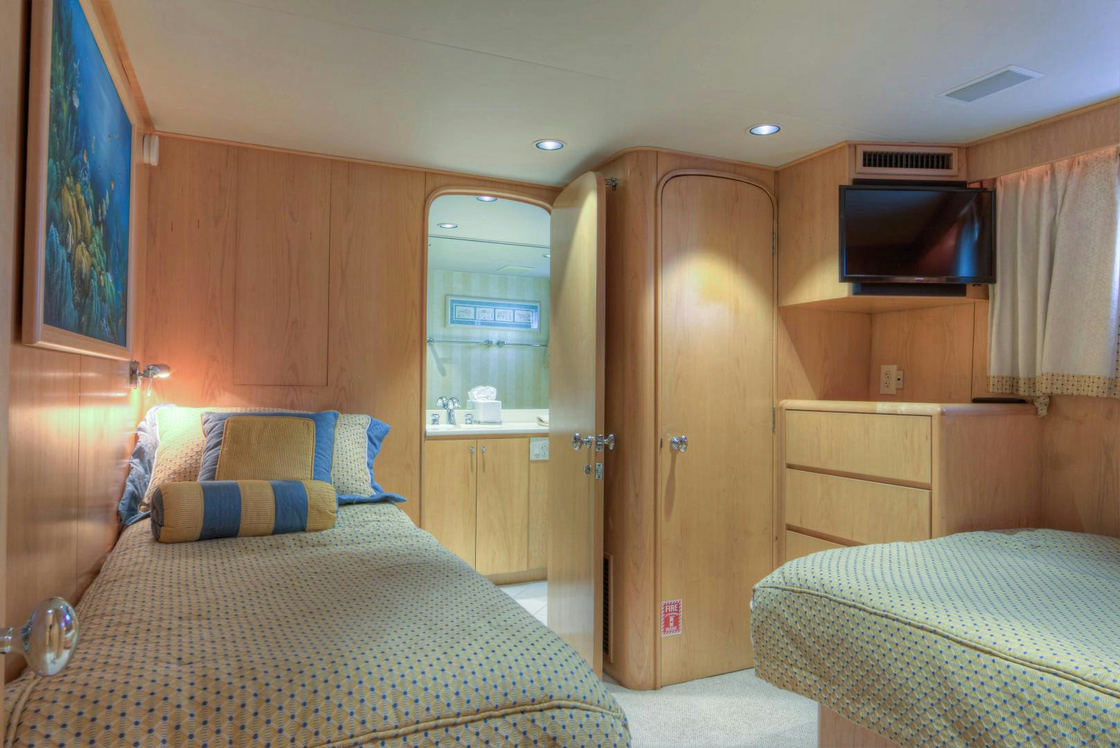 a bedroom with a bed and a television aboard LADY LEX Yacht for Sale