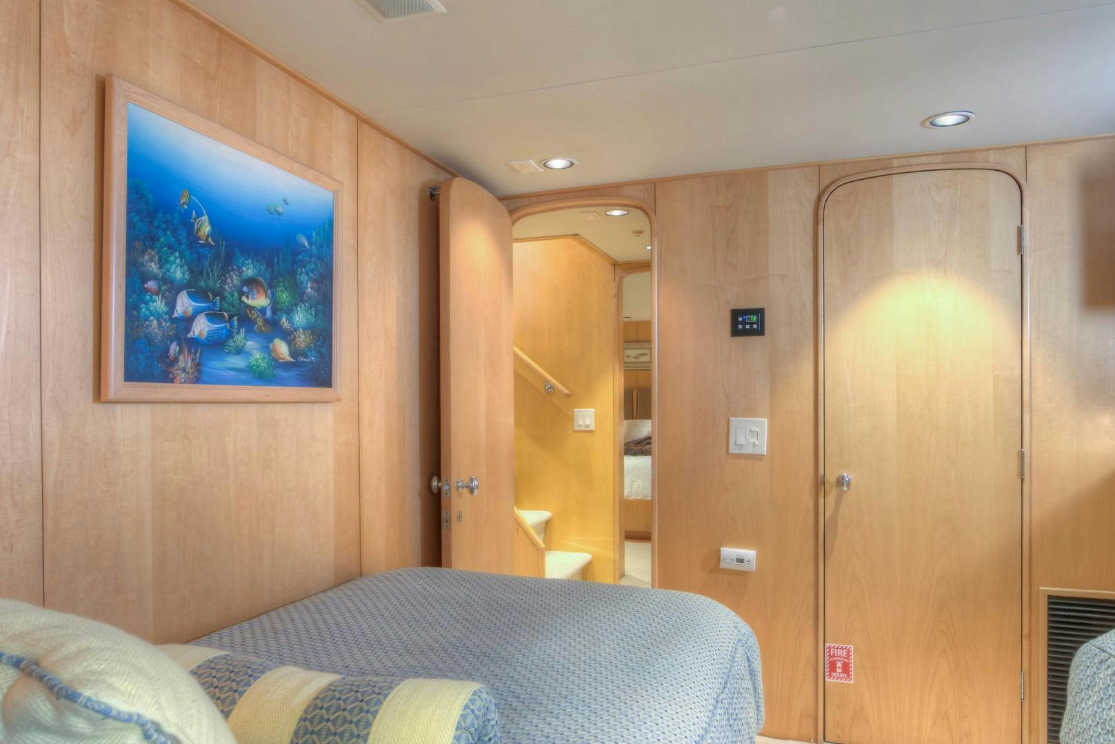a bedroom with a bed and a door aboard LADY LEX Yacht for Sale
