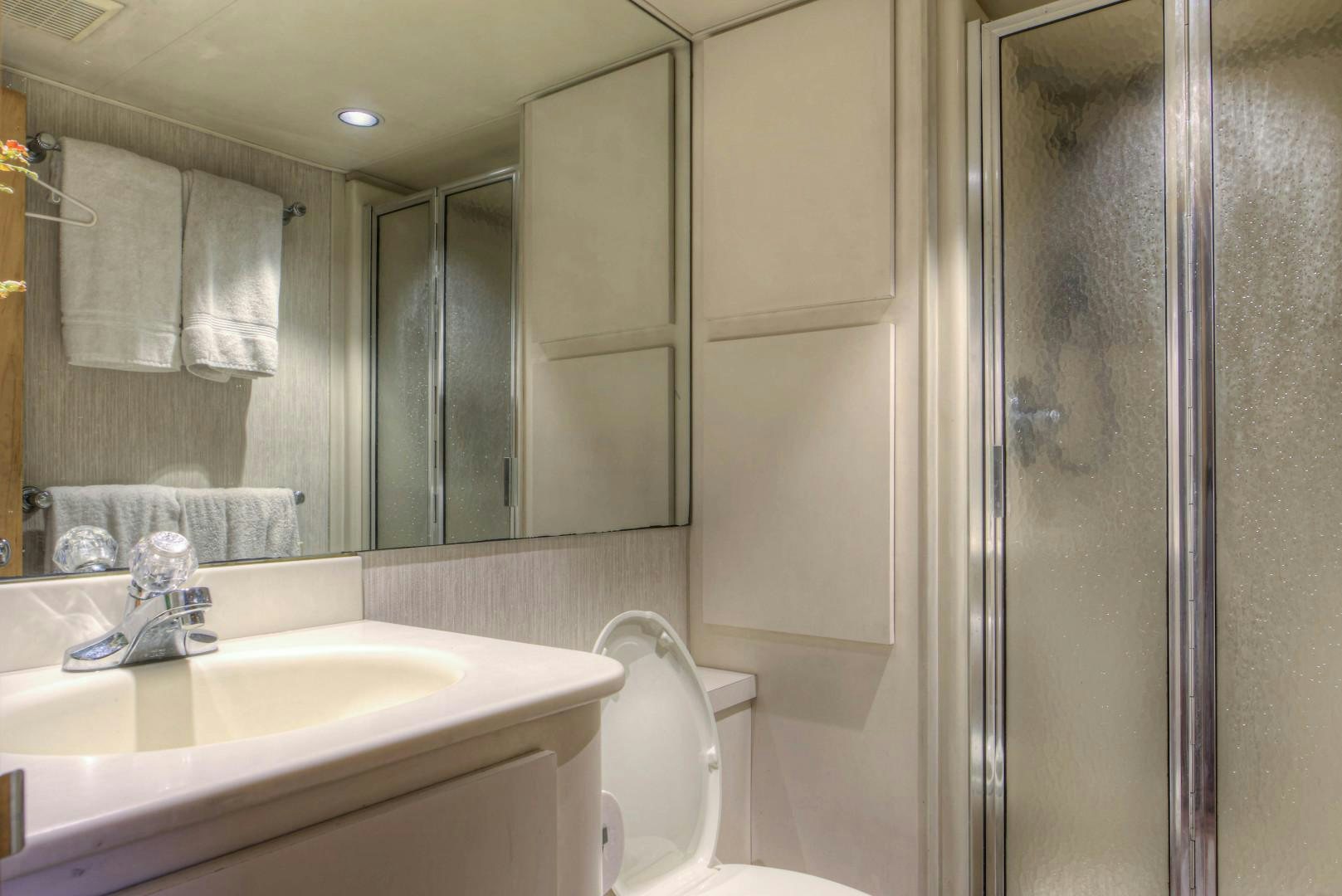 a bathroom with a glass shower aboard LADY LEX Yacht for Sale