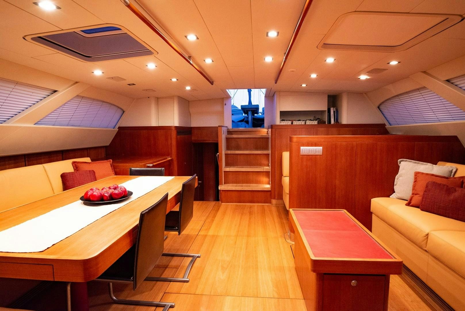 a room with a table and couches aboard VARSOVIE Yacht for Sale