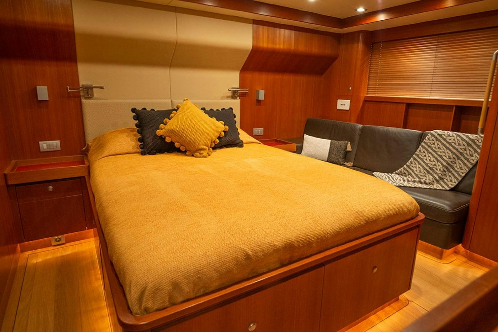 a bed with a couch and a chair in a room aboard VARSOVIE Yacht for Sale