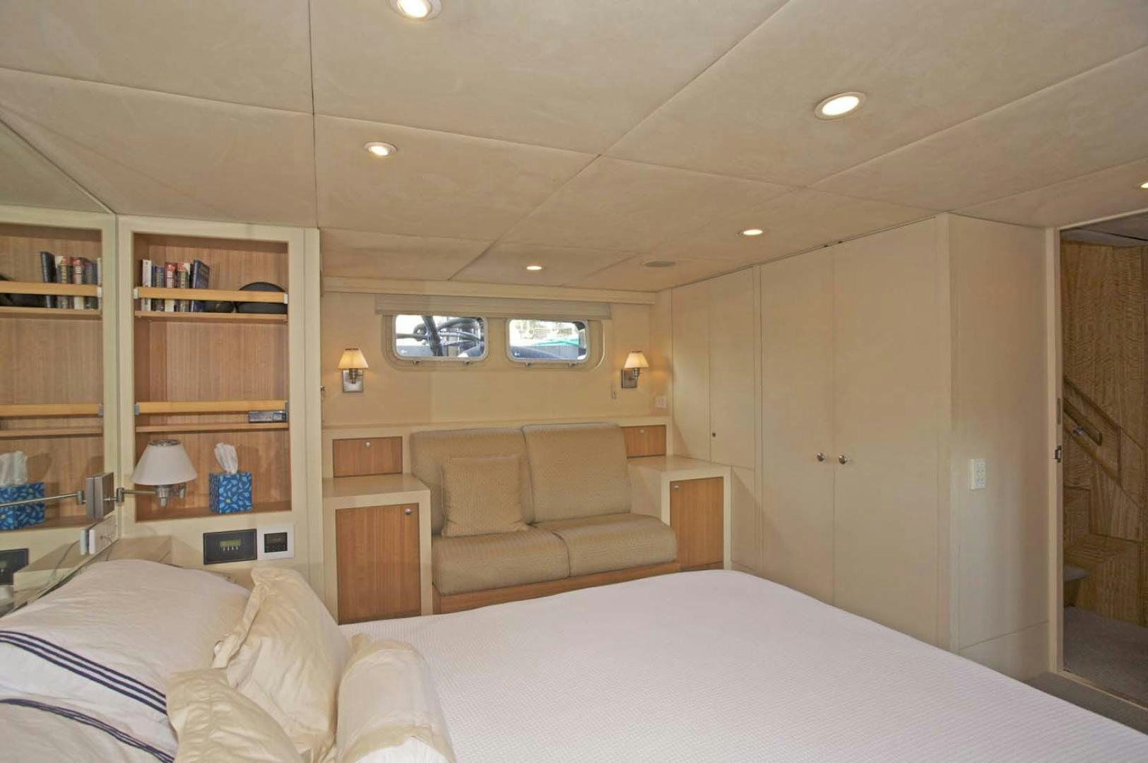 a bedroom with a bed and a couch aboard BRAVO Yacht for Sale