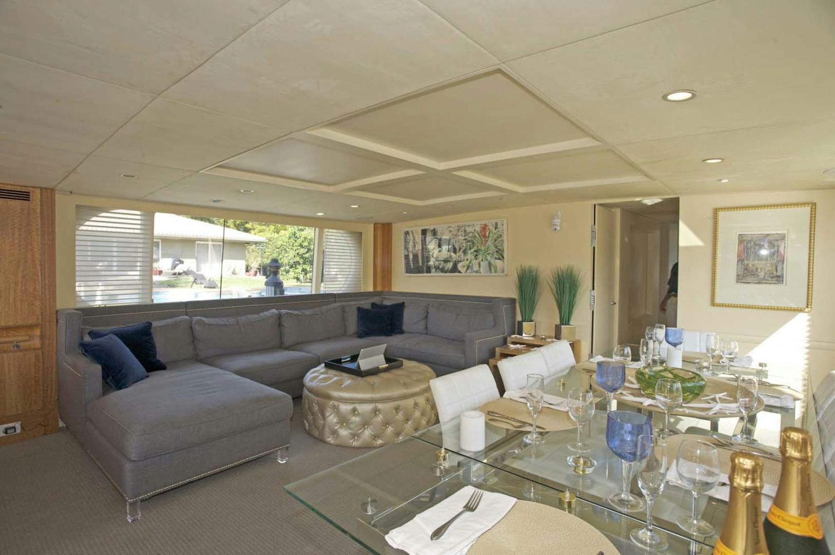 a living room with a couch and a table aboard BRAVO Yacht for Sale