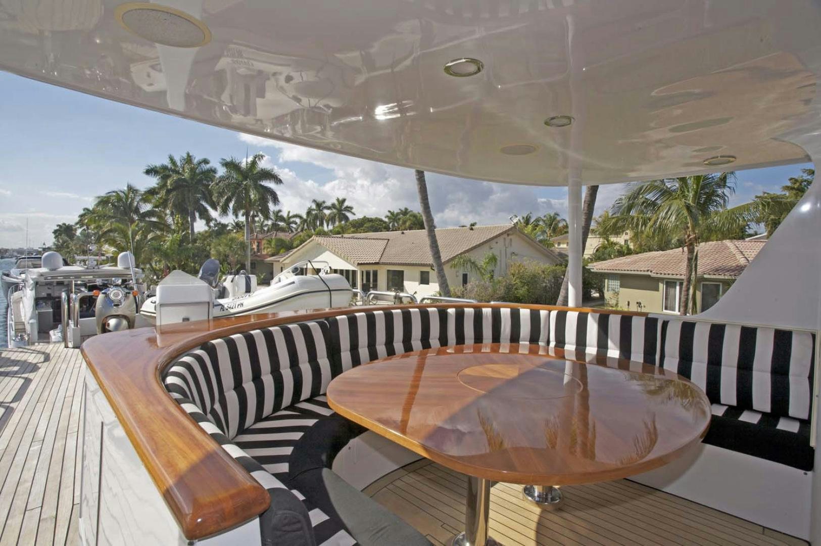 a deck with a large white umbrella aboard BRAVO Yacht for Sale