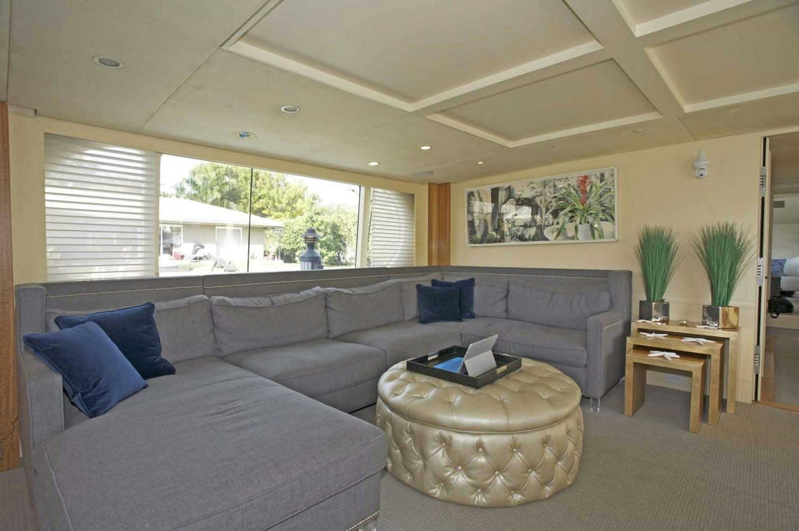 a living room with a couch and a coffee table aboard BRAVO Yacht for Sale
