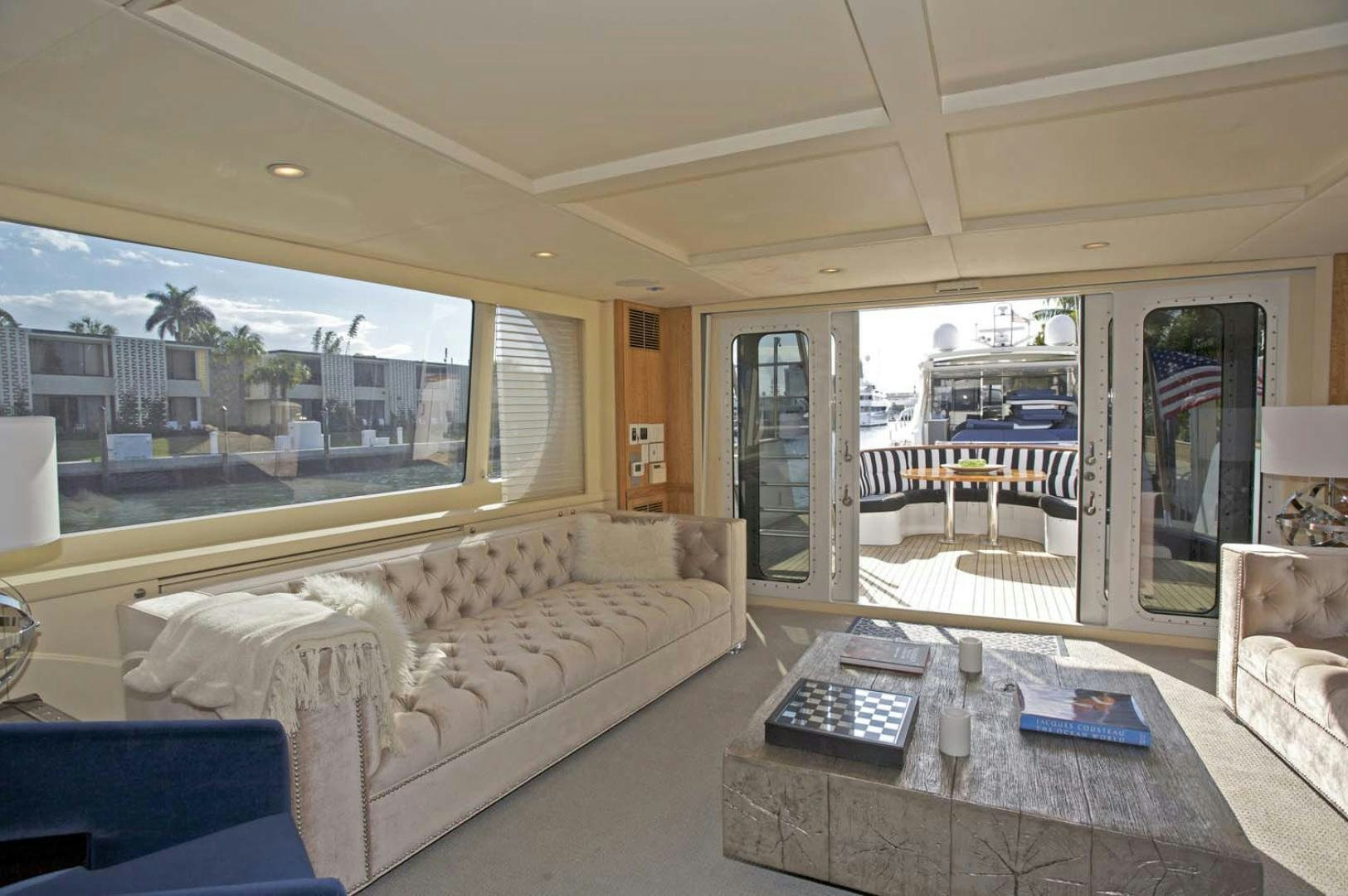 a living room with a large window aboard BRAVO Yacht for Sale