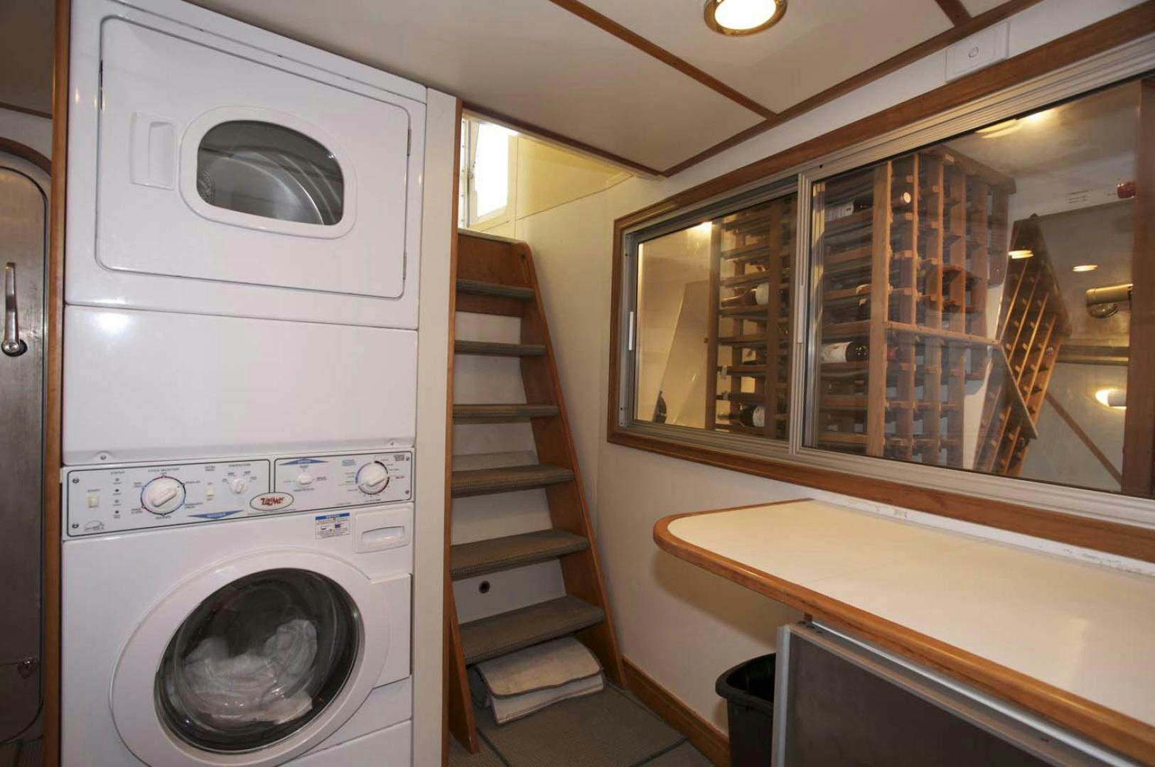 a laundry room with a washer and dryer aboard BRAVO Yacht for Sale