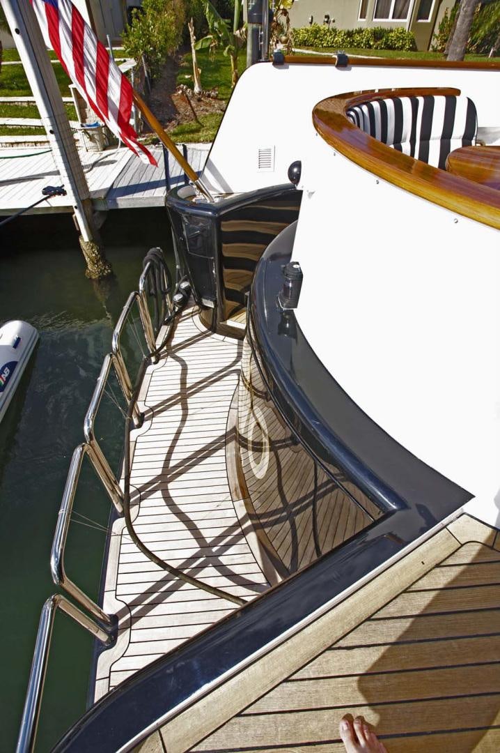 a boat with a flag on the deck aboard BRAVO Yacht for Sale