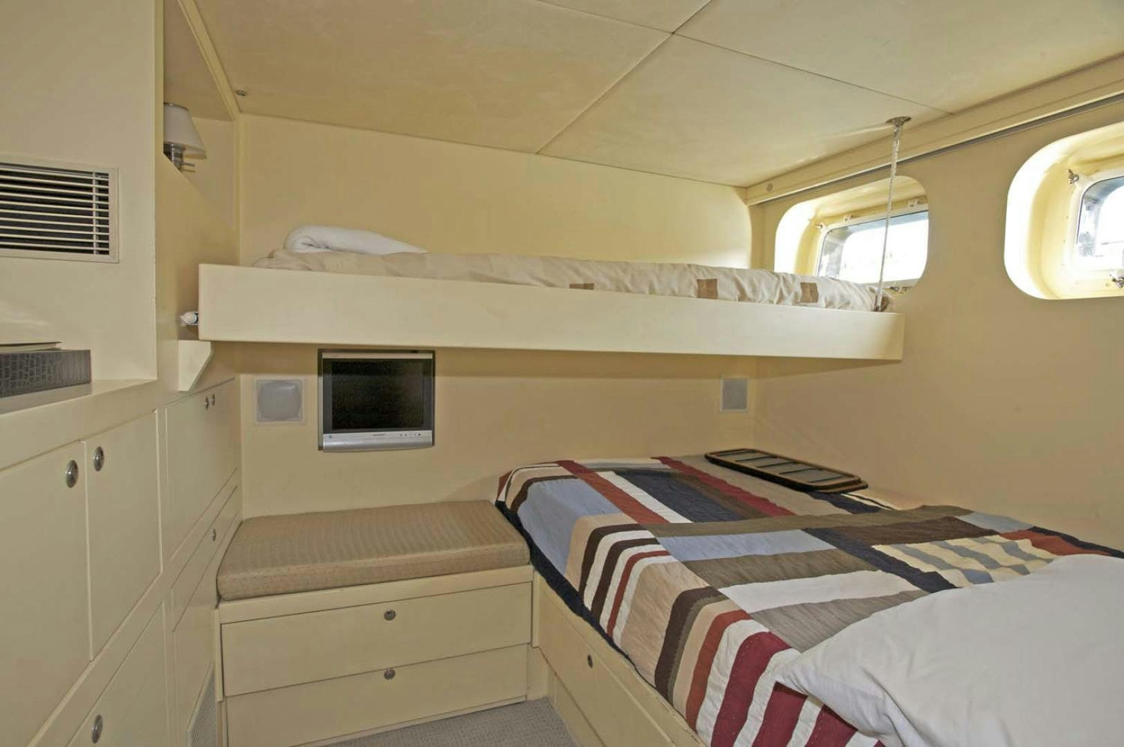 a small bedroom with a bed aboard BRAVO Yacht for Sale
