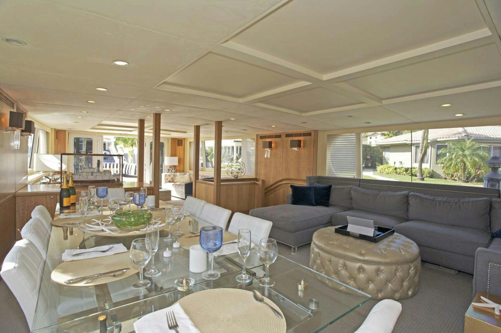 a large living room with a large table and chairs aboard BRAVO Yacht for Sale