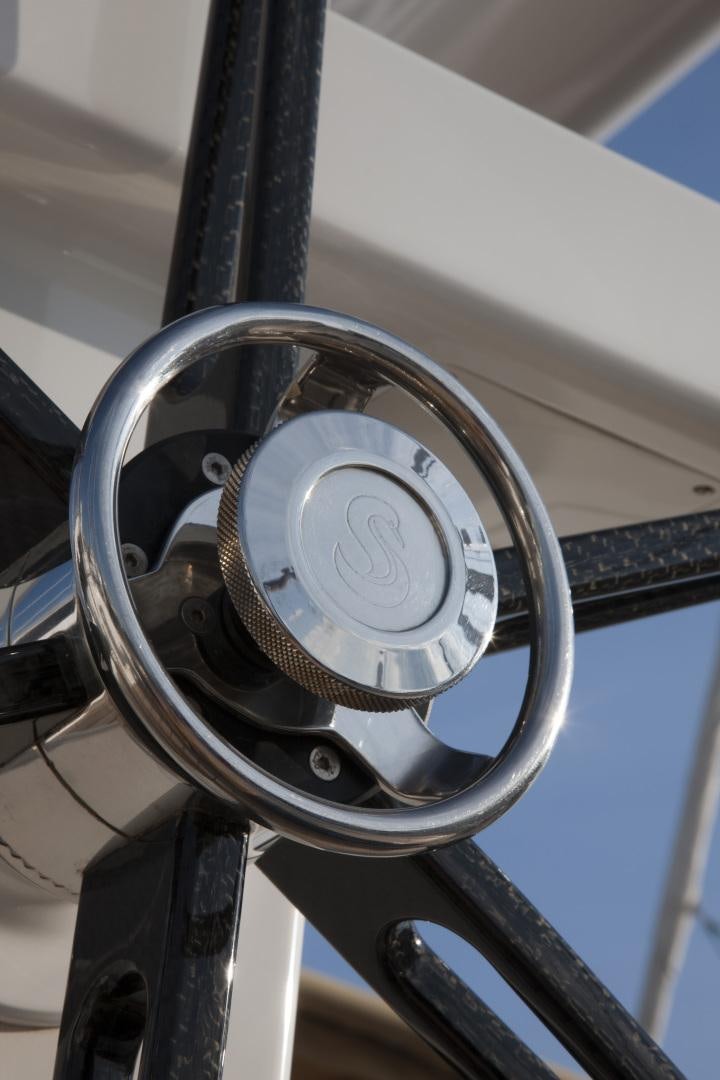 a close-up of a steering wheel aboard VIRAGO Yacht for Sale